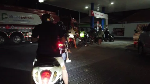 Motorcycles, scooters queue in line for charging fuel, petrol in Pertamina Stock Footage 314811653
