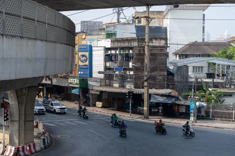 Motorcycles turning at intersection under elevated roadway Fotos Stock