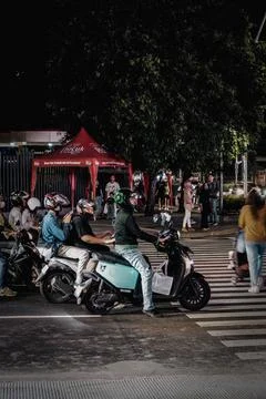 Motorcyclist are Queueing at the Traffic Light in the Evening Stock Photos