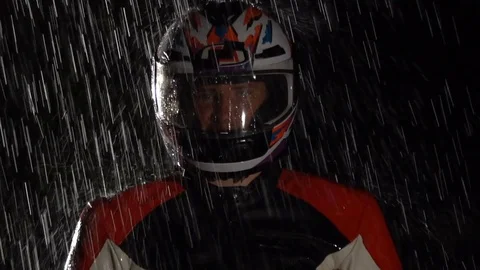Motorcyclist in the helmet looking at the camera in the rain. Stock Footage 80179622
