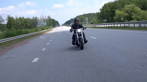 Motorcyclist maneuvers on the road Stock Footage 80320682
