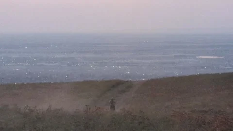 A motorcyclist rides down a hill Video stock 295487293