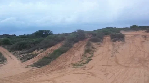 A motorcyclist rides in the dune Stock Footage 168549399