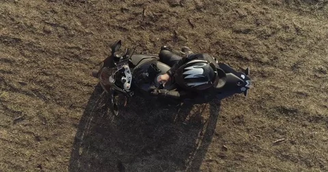 A motorcyclist rides the field Stock Footage