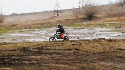 Motorcyclist rides on soft ground Stock Footage 68940978