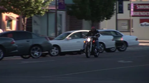 Motorcyclist Riding down street Vídeo Stock 50770409