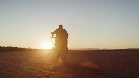 Motorcyclist riding into the sunset Stock Footage 264128795