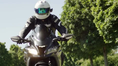 Motorcyclist Riding Toward Camera on Tree Lined Avenue, Summer Ride, Front Shot Stock Footage 341444799