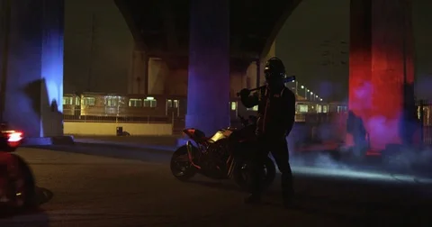 Motorcyclist Stands with Others Doing Tricks Around Him Stock Footage 71789211