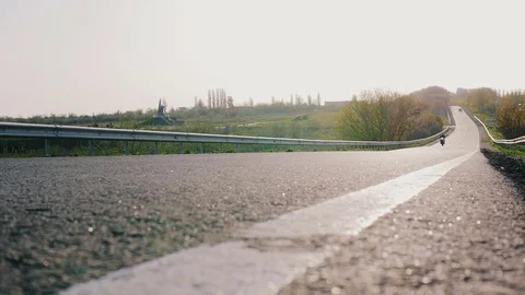 Motorcyclist surfing on high speed on his motorbike on the road in sun beams Stock Footage