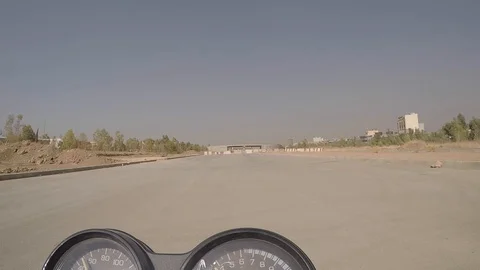 A motorcyclist is testing himself by driving between two cement barricades Video stock 120763924
