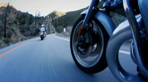 Motorcyclists are riding down a mountain highway. 库存影片 554342