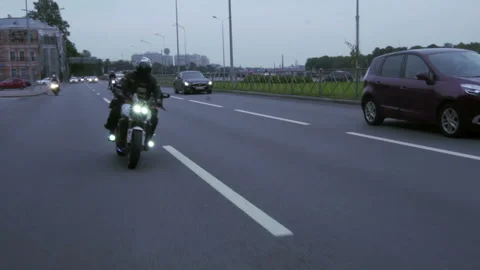 Motorcyclists drive down the road Video stock 102361100