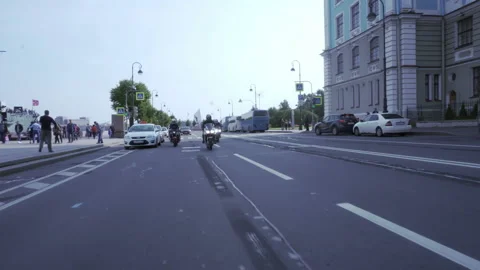 Motorcyclists drive past the square Video stock 102359771