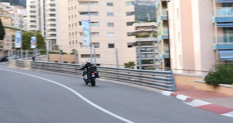 Motorcyclists drive through the Formula One trail in Monte Carlo Vídeos de archivo 107139319