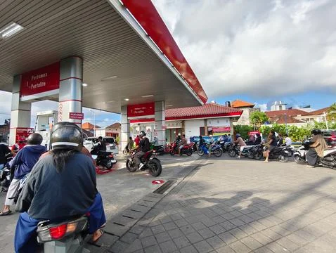 Motorcyclists queue for fuel at Pertamina gas station Stock Photos