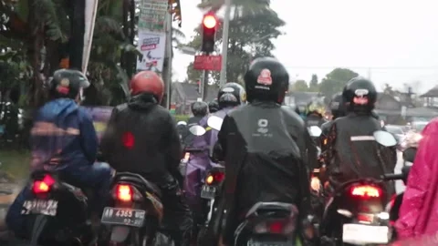 Motorcyclists in the rain on the streets Stock Footage 228143340