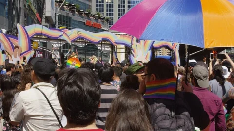 Motorcyclists ride down a crowded Toronto street for the annual pride parade - Stock Footage 124346216