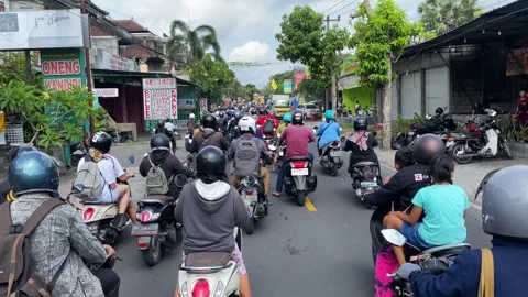 Motorcyclists ride through a congested traffic in Bali, Indonesia 4K Stock Footage 255634744