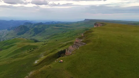 A motorhome is parked on the edge of a cliff overlooking the Gumbashi Pass Stock Footage 323346530