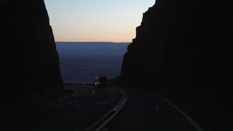 Motorhome passing camper van on the road at night on a steep mountain road Stock Footage 252642890