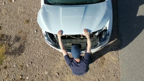 Motorist Stranded in The Desert with Broken Down Car Stock Footage 97730562