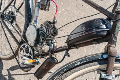 Motorized Bicycle Engine Close-Up with Protective Cover and Worn Frame 스톡 사진