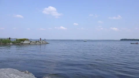 Motorized canoe on a big lake Stock Footage 54370353