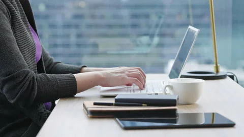 Motorized dolly shot of using laptop computer, out focus city background Video stock 194407538