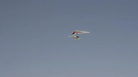 Motorized hang glider soaring in the blue sky Stock Footage 62636907