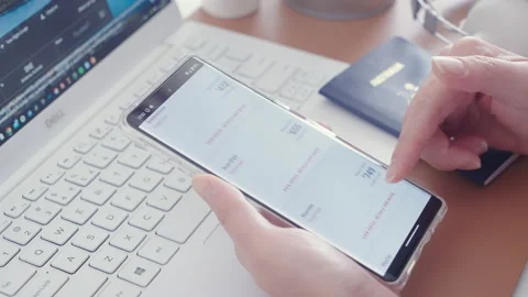Motorized jib shot of browsing flight deal in the Qantas app Video stock 219906788