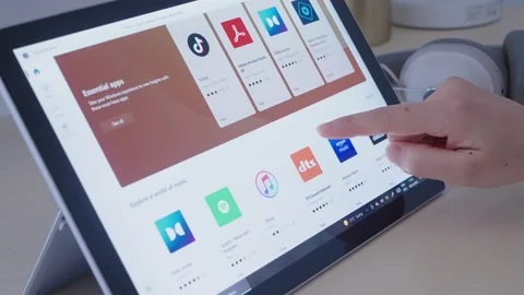 Motorized jib shot of browsing Microsoft Store using a tablet pc Stock Footage 168222717