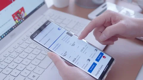Motorized jib shot of browsing the private health insurance on Medibank website Stock Footage 220390332