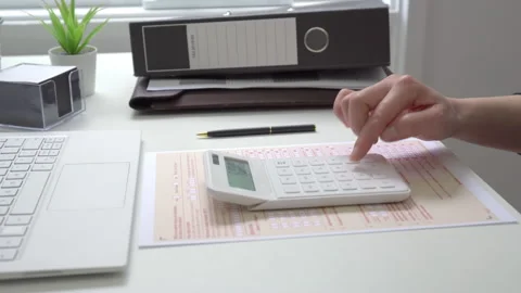 Motorized jib shot of completing Australian tax form Stock Footage 137219209