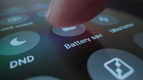 Motorized macro moving shot of turn on battery saver on a smartphone Stock Footage 217427934