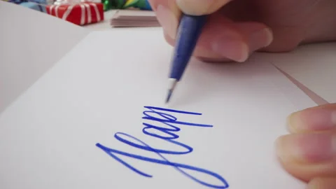 Motorized macro moving shot of writing Happy Birthday on a greeting card Stock Footage 221457041