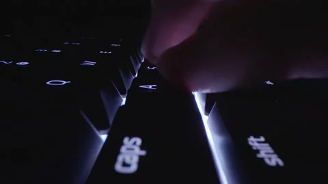Motorized moving macro shot of typing using backlit keyboard Video stock 168047614