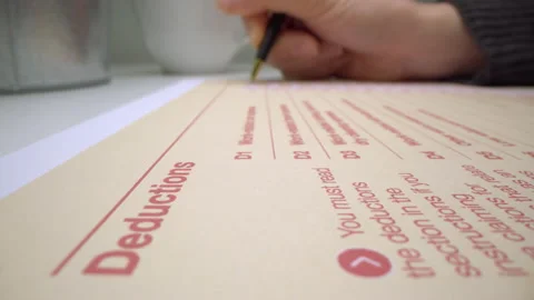 Motorized moving shot of completing deduction section in Australian tax form Stock Footage 137565096