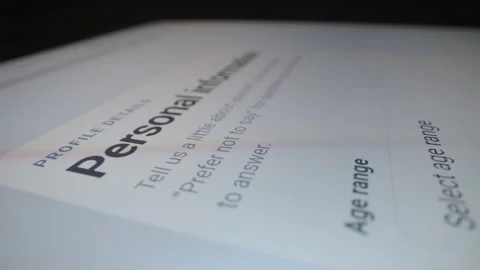 Motorized moving shot of completing demographic information form on tablet Stock Footage 343491909