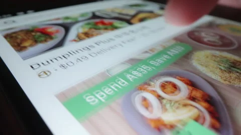 Motorized moving shot of ordering takeaway delivery using Uber Eats app Stock Footage 224198562