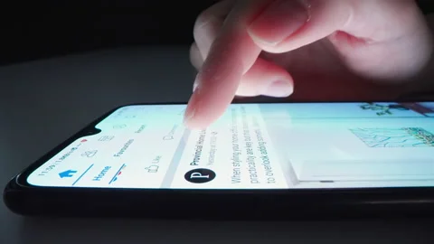 Motorized moving shot of using Facebook app in smartphone Stock Footage 157765857