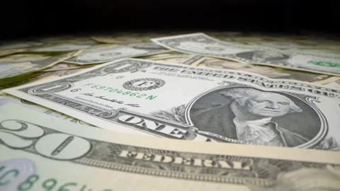 Motorized moving shot of various banknotes of the US dollar Stock Footage 136360275