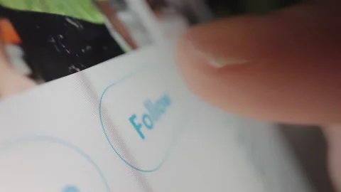 Motorized moving slow motion shot of clicking the follow button in Twitter Video stock 142769764