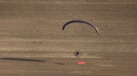 Motorized parachute hits the target during competition of ultralight airplanes Stock Footage 18120385