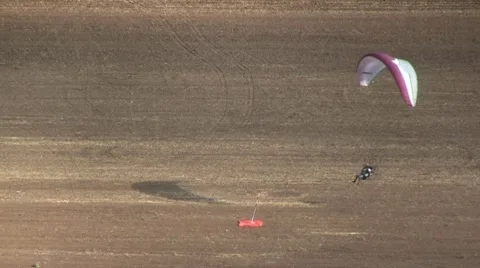Motorized parachute hits the target during competition of ultralight airplanes Stock Footage 18120773