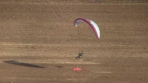 Motorized parachute hits the target during competition of ultralight airplanes Stock Footage 18121143