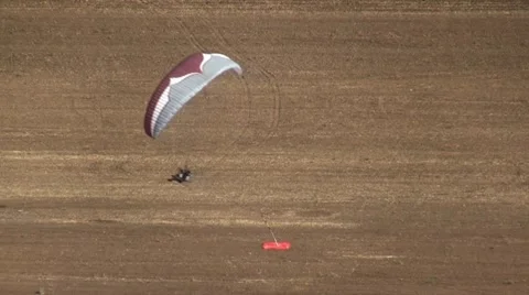 Motorized parachute hits the target during competition of ultralight airplanes Stock Footage 18121443