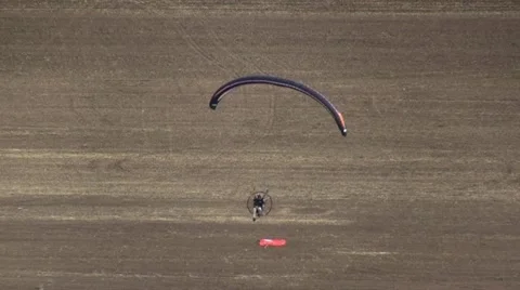 Motorized parachute hits the target during competition of ultralight airplanes Stock Footage 18122087