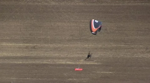 Motorized parachute hits the target during competition of ultralight airplanes Stock Footage 18122310
