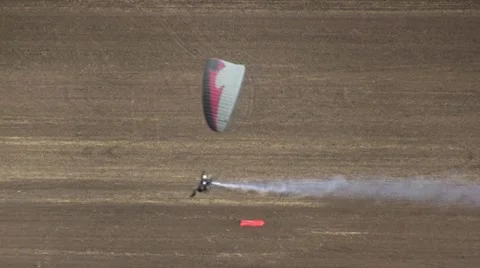 Motorized parachute hits the target during competition of ultralight airplanes Stock Footage 18124458